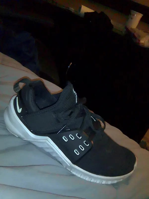 Black Sneaker On Bed