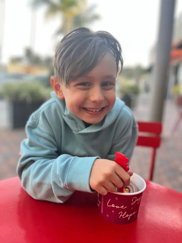 Child At Outdoor Cafe Table