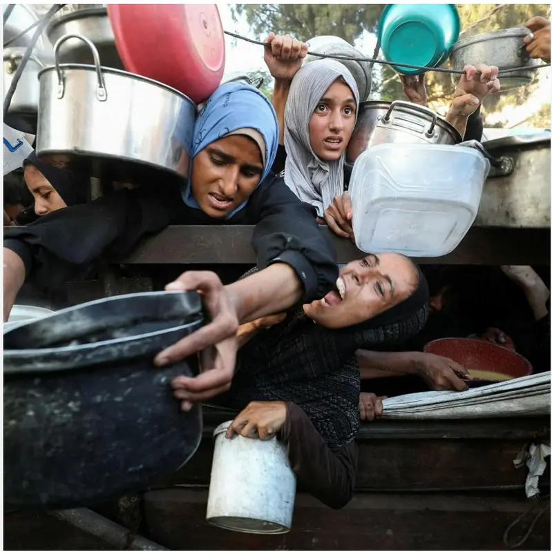 Crowd Reaching For Supplies
