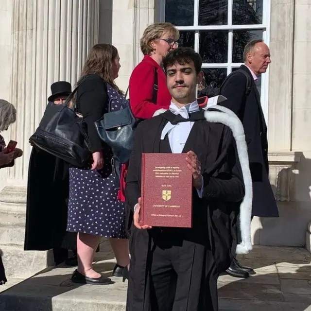 Graduate Holding Diploma Outdoors