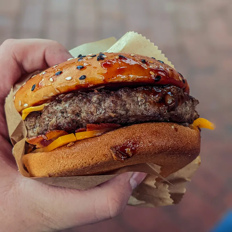 Hand Holding Glazed Burger