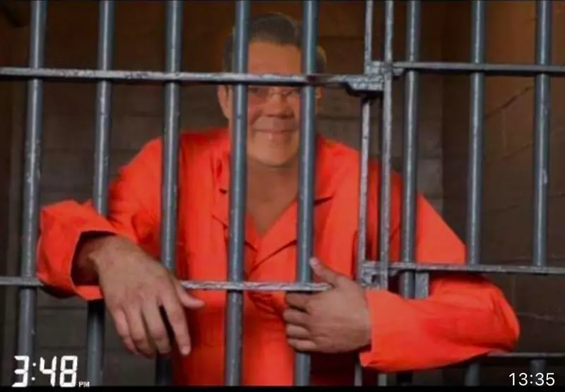 Inmate Behind Bars Smiling