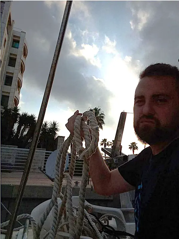 Man Holding Ropes On Boat