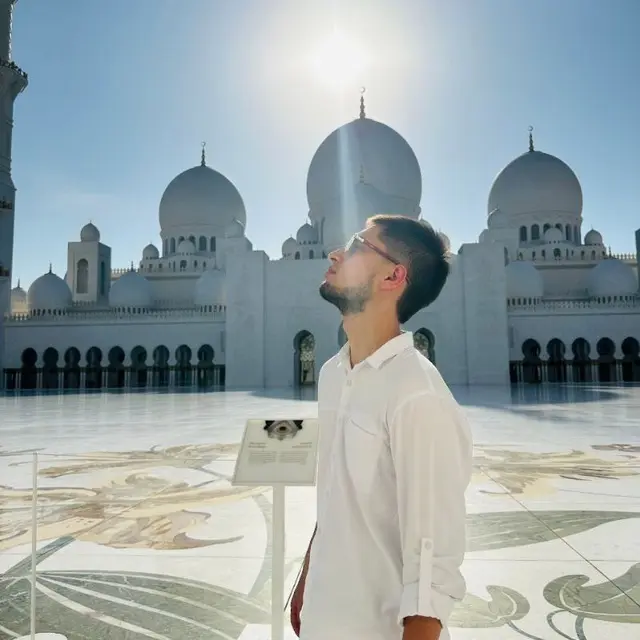 Man Near Mosque In Sunlight