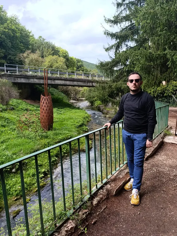 Man Standing By Stream