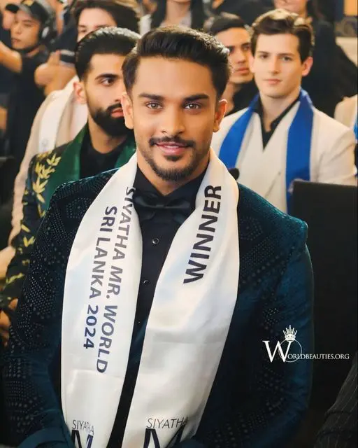 Man With Winner Sash Seated