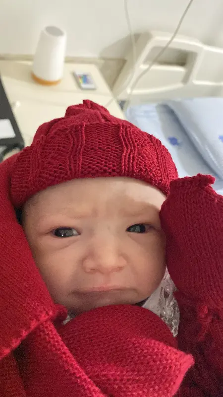 Newborn In Red Knitwear