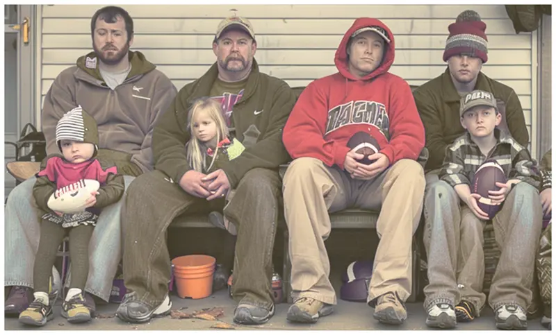 People Holding Footballs Together