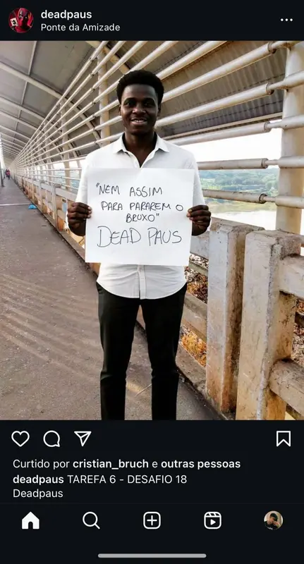 Person Holding Sign On Bridge