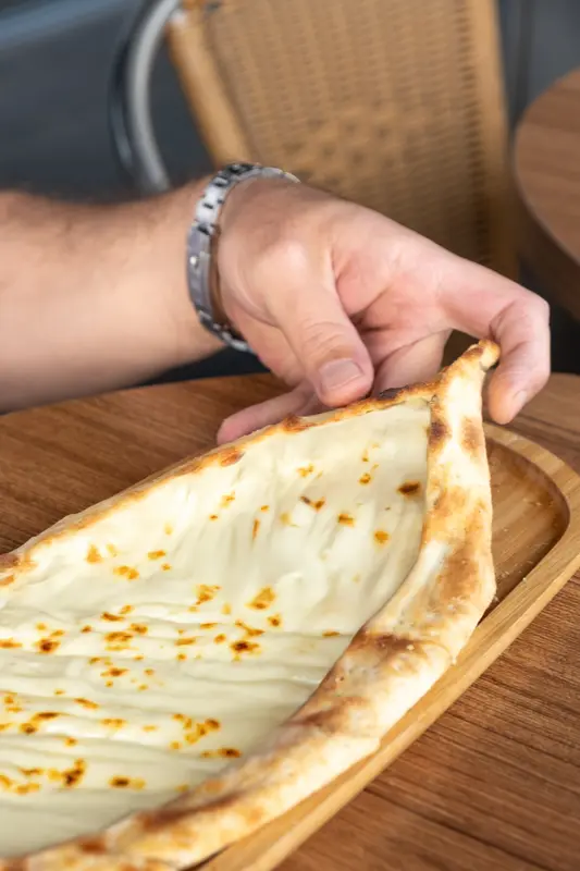 Person Holding Turkish Pide