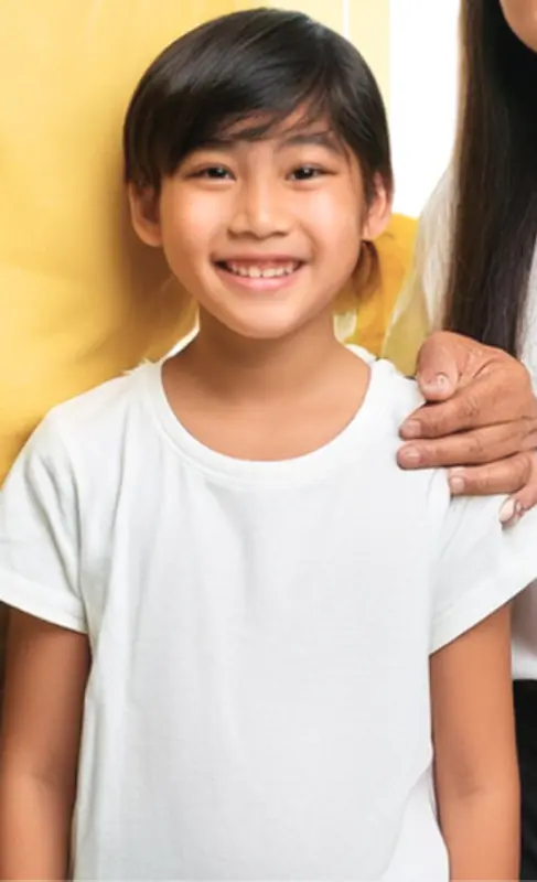 Smiling Child With Shoulder Support
