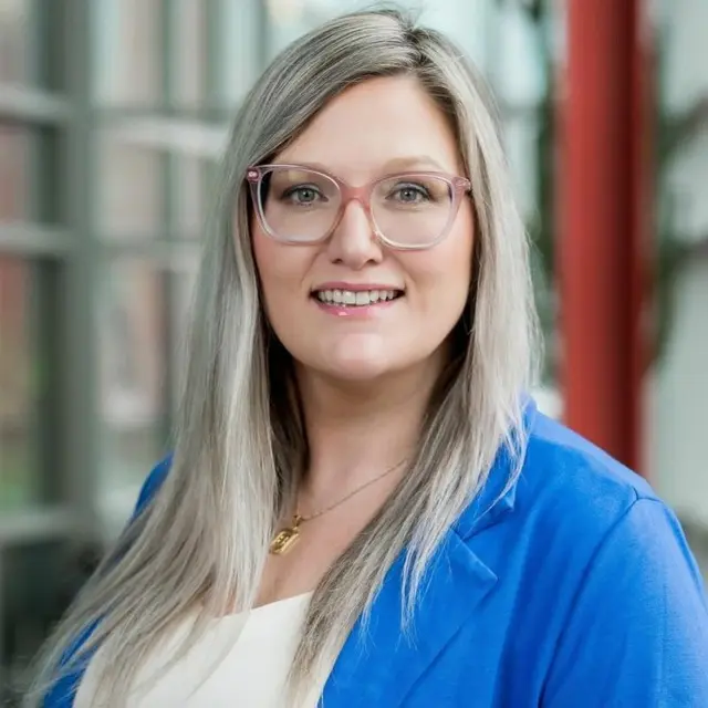 Smiling Person In Blue Blazer