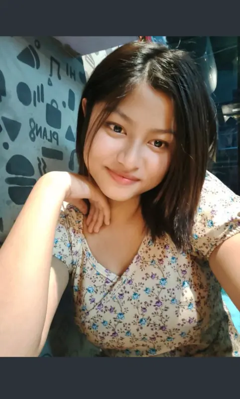 Smiling Person With Floral Top