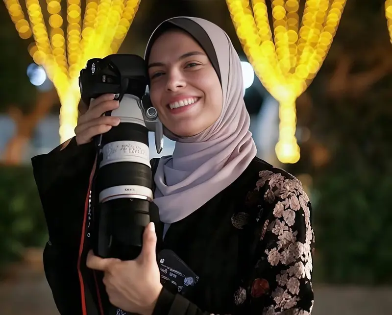 Smiling Person With Large Camera