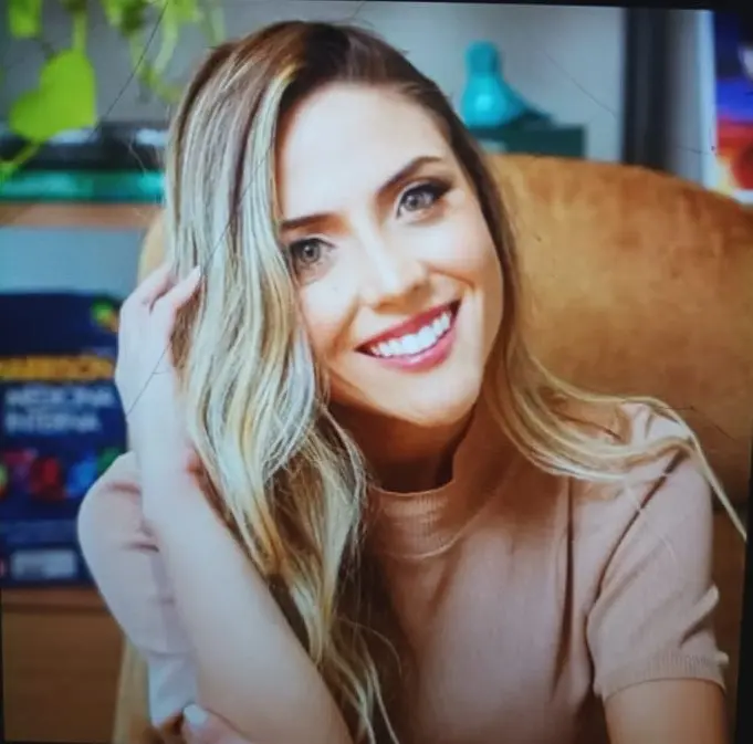 Smiling Woman On Tan Chair