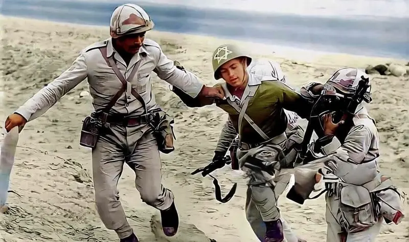 Soldiers Assisting Another In Desert.