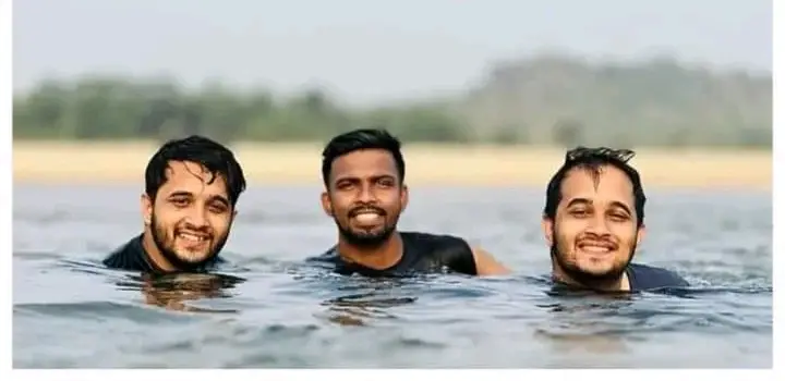 Three Men Swimming Outdoors
