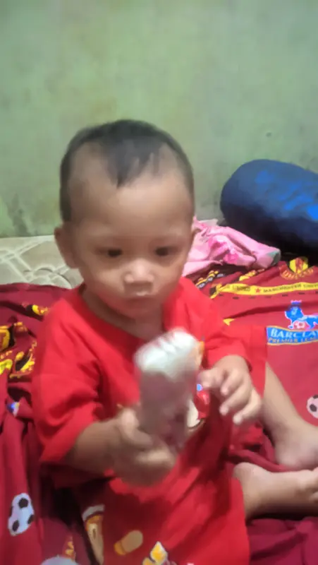 Toddler Sitting On Bed