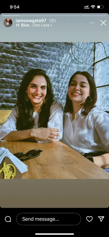 Two Smiling Women At Table