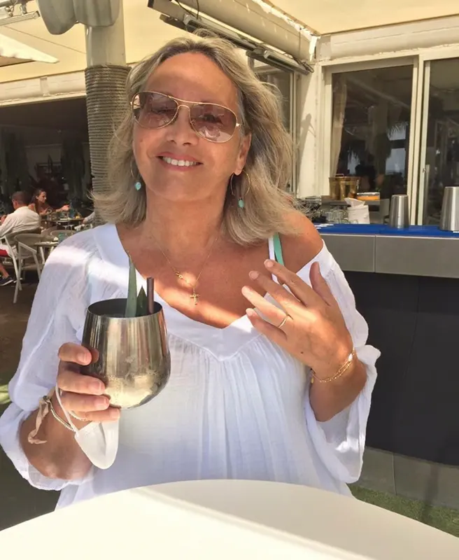 Woman Holding Cocktail, Smiling.