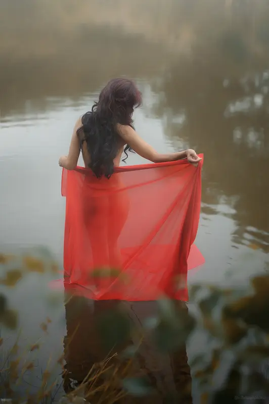 Woman In Red Fabric By Water