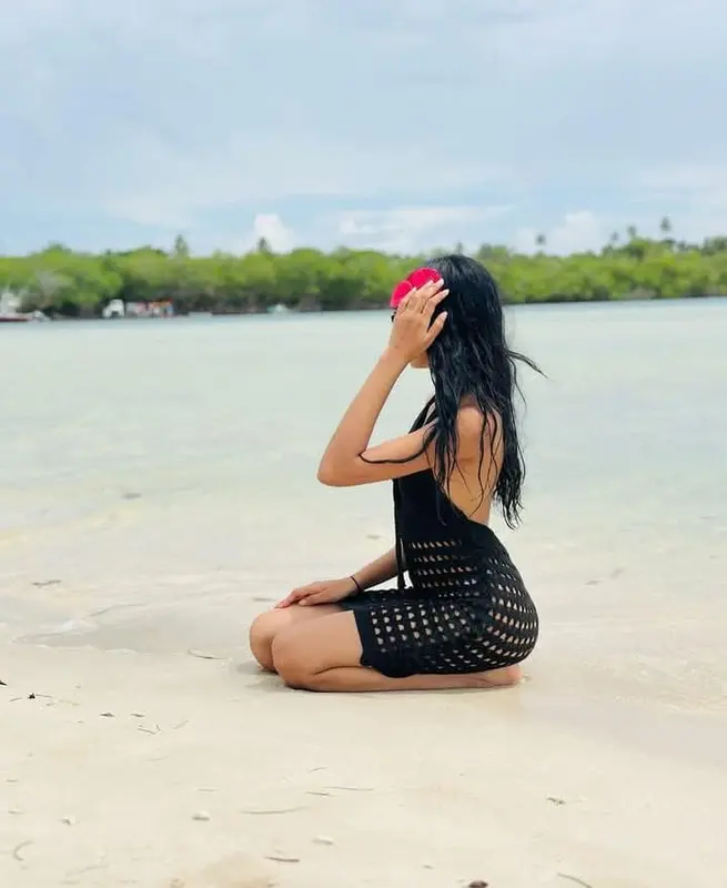 Woman Kneeling On Beach