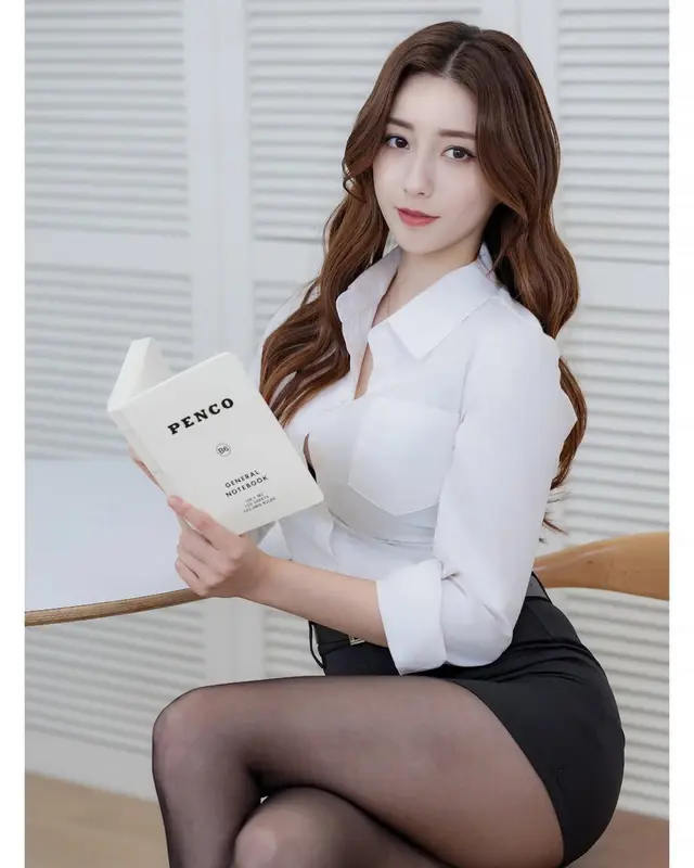 Woman Reading Book At Table