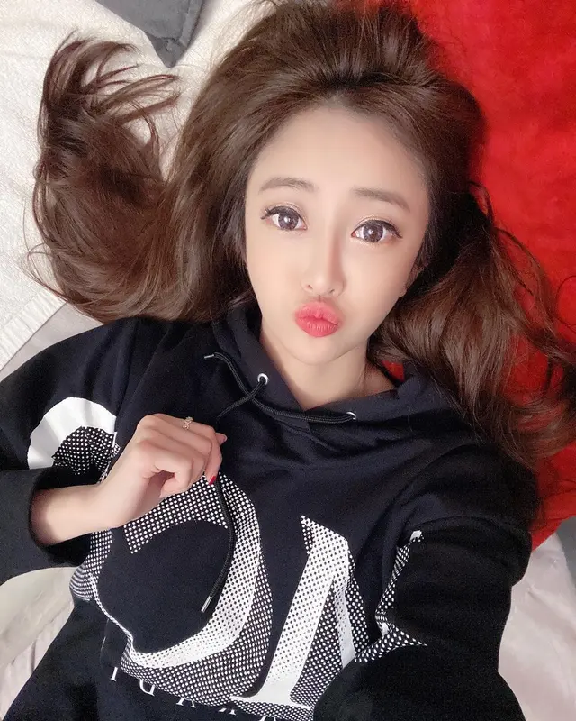 Woman Relaxing On Bed