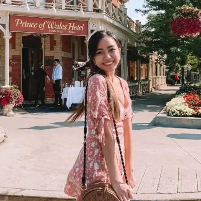 Woman Smiling Near Historic Hotel