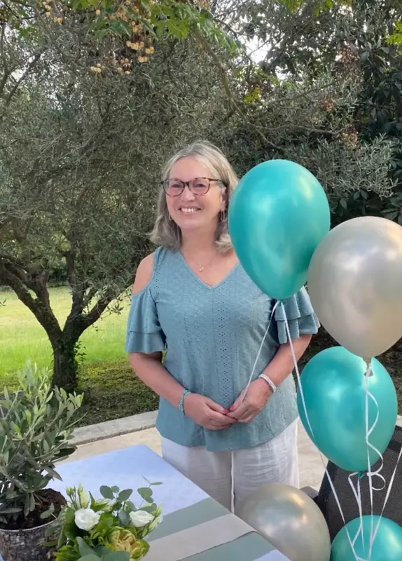 Woman With Balloons In Garden