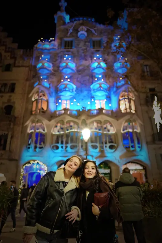 Women In Front Of Illuminated Building